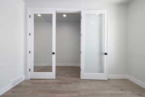 Unfurnished bedroom featuring a closet and hardwood / wood-style floors