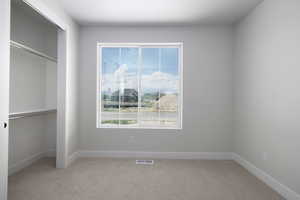 Unfurnished bedroom featuring a closet and carpet floors