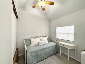 Bedroom features a full wall length closet, built ins, and lofty vaulted ceilings!