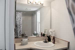 Bathroom with bathtub / shower combination and vanity.  Nice linen closet!