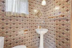 Guest Half Bathroom featuring tile floors and toilet