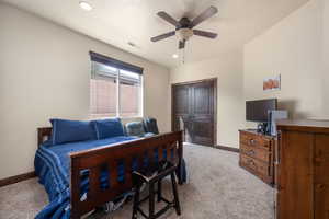 Bedroom with light carpet, a closet, and ceiling fan