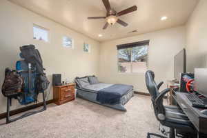 Bedroom with ceiling fan and carpet flooring