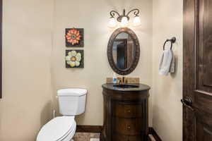 Bathroom with tile flooring, vanity, and toilet