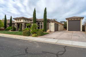 Mediterranean / spanish home featuring a garage