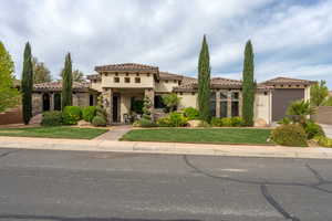 Mediterranean / spanish home featuring a front yard