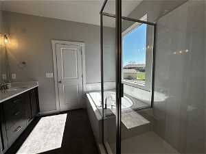 Bathroom featuring oversized vanity and plus walk in shower