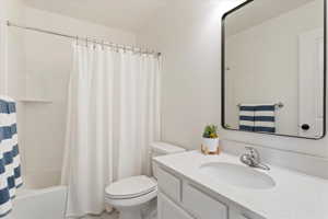 Full bathroom featuring large vanity, shower / bath combination