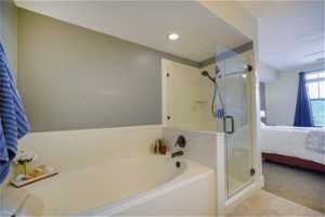 Bathroom with plus walk in shower and tile floors