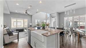 Kitchen featuring pendant lighting, white cabinetry, dark hardwood / wood-style floors, a kitchen island, and ceiling fan