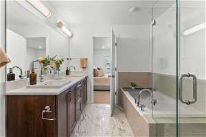Bathroom with shower with separate bathtub, tile floors, and dual vanity