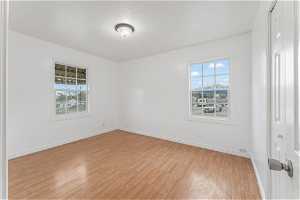 Unfurnished room with light hardwood / wood-style floors and a wealth of natural light