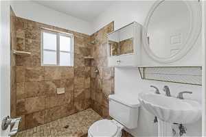 Bathroom with tiled shower and toilet