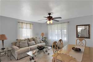Living room with tile flooring and ceiling fan