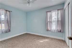 Spare room featuring ceiling fan and carpet floors