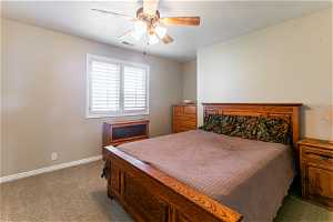 Bedroom featuring ceiling fan, carpet floors, and a textured ceiling