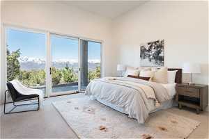 Bedroom featuring a mountain view, carpet flooring, and access to exterior