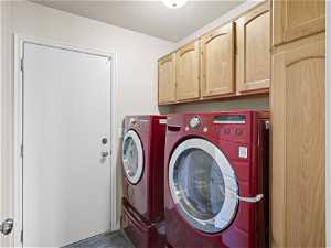 Washroom on main- with dark tile flooring, cabinets, independent washer and dryer included. (If buyer wants it)