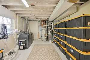 Interior space featuring water heater and washer and dryer