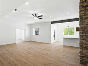living room featuring light hardwood / wood-style flooring and ceiling fan