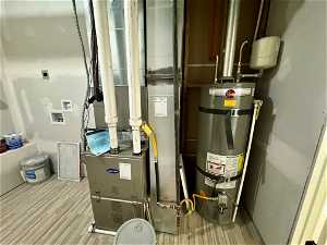 Utility room with secured water heater and laundry hookups