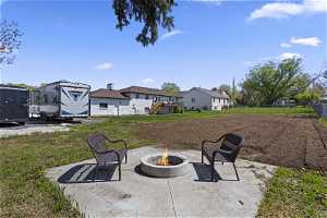 View of yard featuring a patio area and an outdoor fire pit