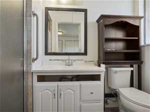 Bathroom with toilet and large vanity