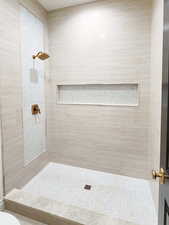 Bathroom with toilet and tiled shower