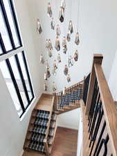 Stairway with a high ceiling and wood-type flooring