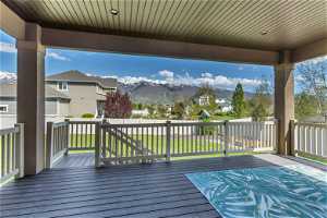Deck featuring a mountain view and a lawn. Comes off of kitchen. IMAGINE THESE VIEWS!!!