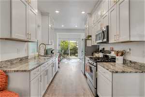 The beautifully remodeled kitchen boasts stainless stainless steel appliances and a gas range