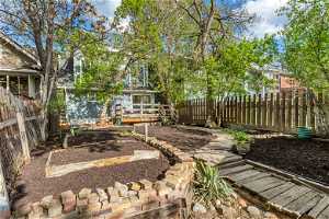 Beautiful view of the backyard with wooden deck and walking path
