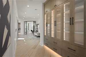 Hall with french doors and light hardwood / wood-style floors