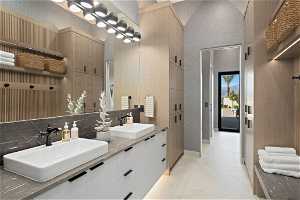 Bathroom featuring a towering ceiling, tile floors, and dual vanity