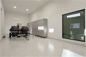 Exercise room with an AC wall unit and a high ceiling