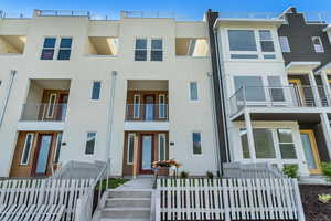 View of front of house featuring a balcony