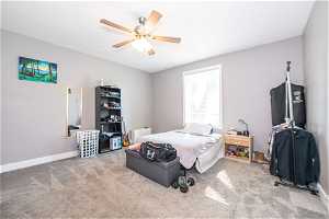 Bedroom featuring ceiling fan and carpet floors