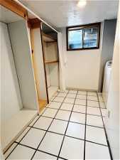 Interior space featuring washer / clothes dryer and light tile flooring