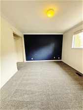Carpeted empty room with ornamental molding
