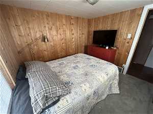 Bedroom featuring wood walls
