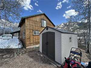 Exterior space featuring a mountain view and a storage shed
