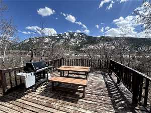 Deck featuring a mountain view and a grill