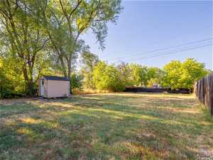 Fully fenced, large yard with storage shed