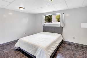 Tiled bedroom with a drop ceiling