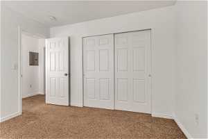 Unfurnished bedroom featuring a closet and carpet flooring