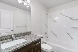 Full bathroom featuring washtub / shower combination, vanity, and toilet
