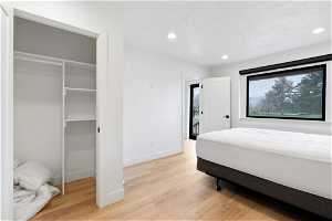 Bedroom featuring light hardwood / wood-style flooring and a closet
