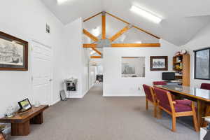 Home office featuring beamed ceiling, high vaulted ceiling, and carpet floors