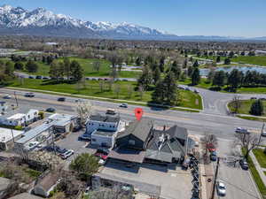 Birds eye view of property with a water and mountain view