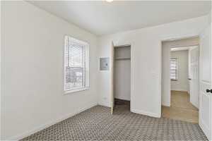 Unfurnished bedroom with tile floors and a closet